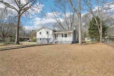 View of front of property with a front yard, a por