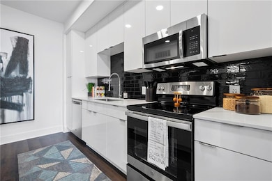 Kitchen with tasteful backsplash, stainless steel 