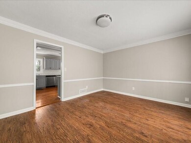 Empty room with ornamental molding, baseboards, da