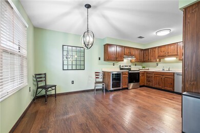 The kitchen offers a dining area with custom light