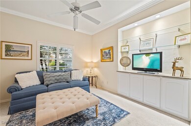 Living room with ceiling fan, ornamental molding,