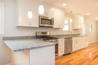 Angle of kitchen showing island area which extends