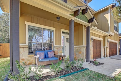 Property entrance featuring a porch, stone siding