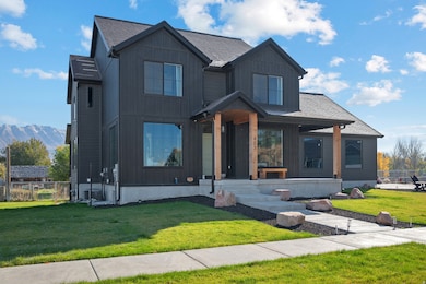 Modern farmhouse style home featuring roof with shingles, a mountain view, and board and batten siding
