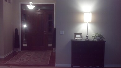FRONT ENTRY WITH HARDWOOD FLOORS AND DOOR