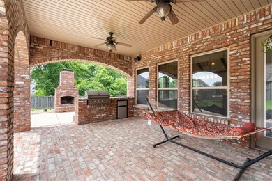 Large covered patio with built-in grill and fridge