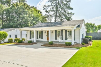 View of front of property with driveway, a porch, 