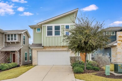 View of front of property with driveway, stone si