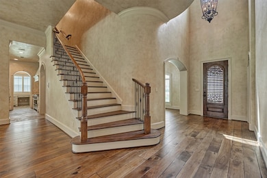 This elegant entryway features a grand staircase w