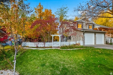 View of front of house with a fenced front yard and driveway