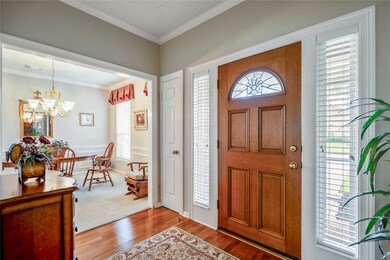 To the right, you'll see the dining room, which leads to the kitchen.