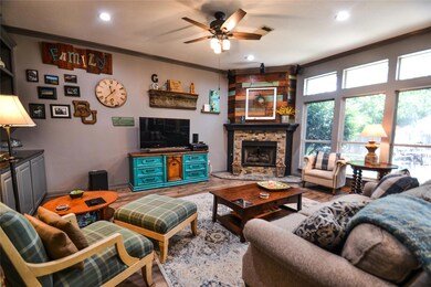 Living area featuring ceiling fan, ornamental mold