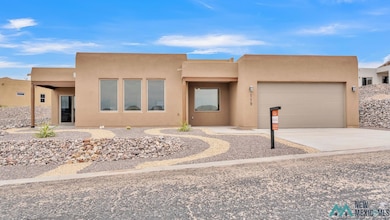 Southwest-style home featuring stucco siding, concrete driveway, and a garage