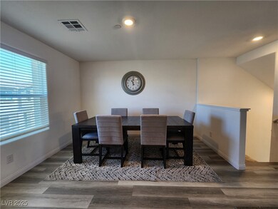 Dining area with wood finished floors and recessed
