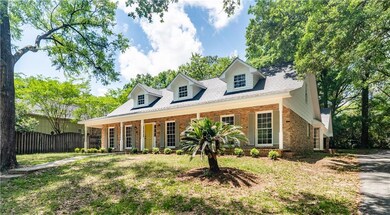Cape cod home featuring brick siding, roof with sh