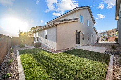 Back of house with a fenced backyard and stucco siding