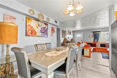 Dining space featuring a chandelier and wood finis