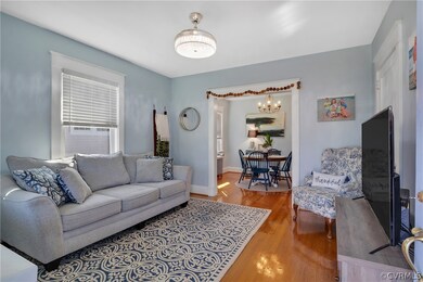 Living room featuring a chandelier and light wood-