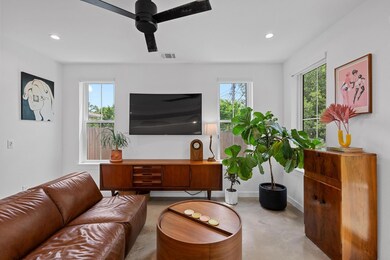Living room featuring concrete flooring, a ceilin