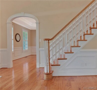 2 story foyer with arches, columns and hardwood fl