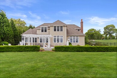 The rear facade of this home features expansive wi