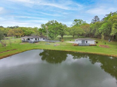 Rear view of house and guest house. Pond is stocke