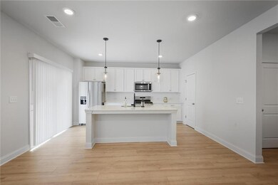 Living area and kitchen located on rear of home ha