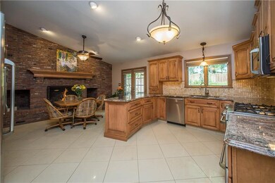 The large, renovated kitchen has custom maple cabi