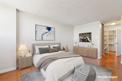 Primary bedroom with a walk in closet. (Virtually 