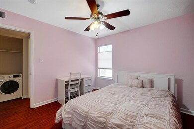 Bedroom with washer / clothes dryer, wood finishe
