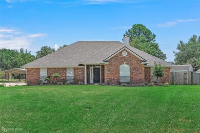 Single story home featuring a front lawn
