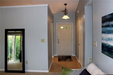 An entry with tiled flooring, updated light fixture, fresh paint, and cathedral ceiling welcomes you.  Notice the coat closet on the right of the entry.  
