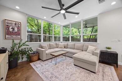 Living room featuring a ceiling fan, recessed lig