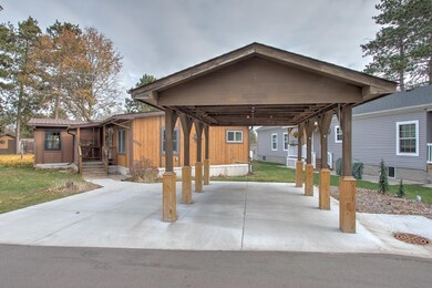 Single carport plus extra parking spot - all new concrete driveway and sidewalk.