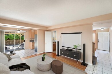 Virtually Staged Family Room/Dining Room looking out to Backyard
