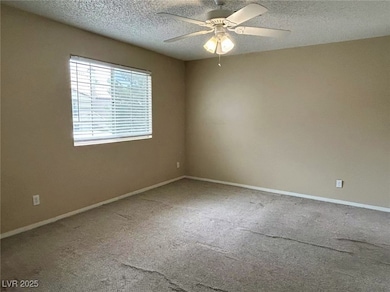 Unfurnished room with carpet, ceiling fan, and a t