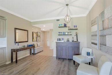 Sitting room featuring ornamental molding, light w