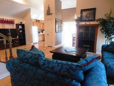 Living area featuring baseboards, light wood-style
