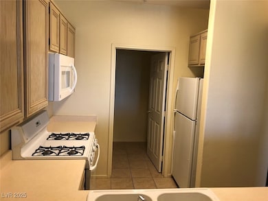 Kitchen featuring white appliances, light tile pat