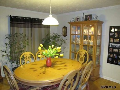 The dining area has hardwood floors and is open to the living room and kitchen.