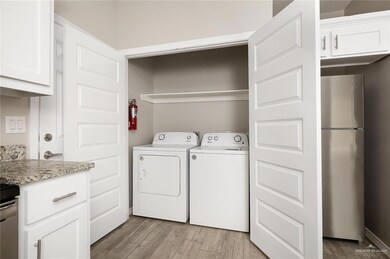 Washroom with light wood-type flooring and separate washer and dryer
