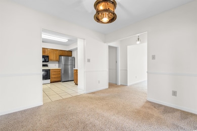 Kitchen with white electric range oven, light colo