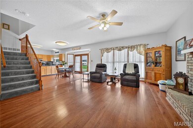 Large Great Room with wood burning fireplace & big picture windows.