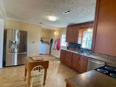 Kitchen with washer and clothes dryer, backsplash,