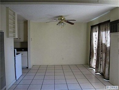 Living Room in A unit with Ceiling Fan and Tile fl