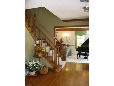 Spacious Foyer with hardwood floor and open stairw