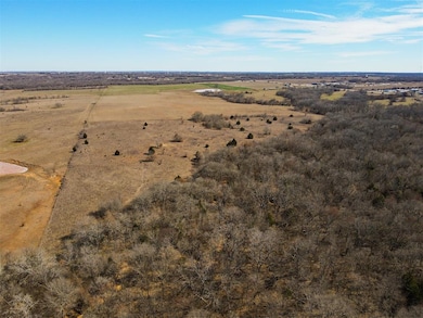 Aerial view of property and surrounding area featuring rural landscape