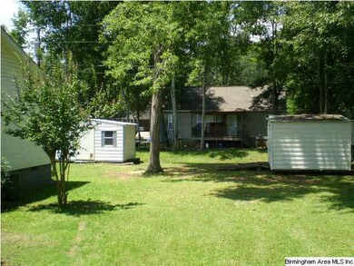 Side view w/ two storage buildings/workshop