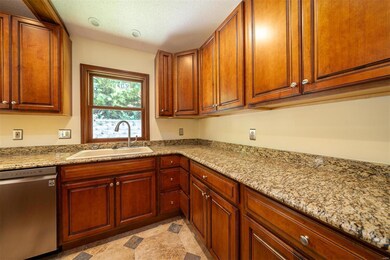 Warm wood cabinets w/granite countertops!