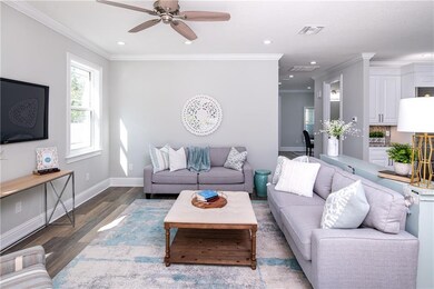 Family room, which is open to the kitchen, has sliders to the back patio and views of the pool.